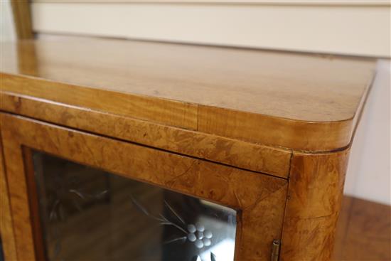 An Art Deco birds eye maple display cabinet and similar dining table,